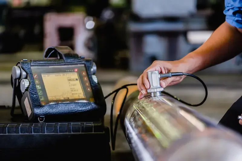 Technician performing non-destructive testing inspection